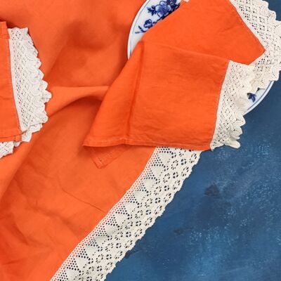 round orange linen tablecloth with four napkins