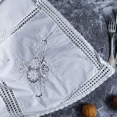 white linen tablecloth with checked crochet inserts