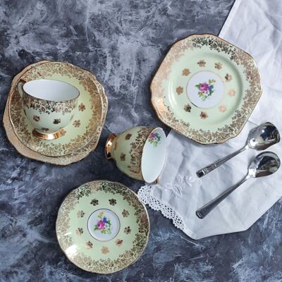 Pair of yellow teacups and gold decoration