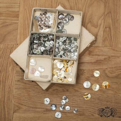 Boxes of gray and yellow mother-of-pearl buttons