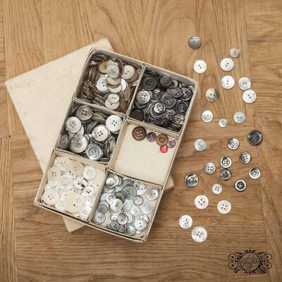 Boxes of large buttons in brown, white and gray mother of pearl