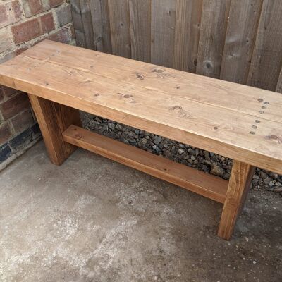 Two person dining bench in a medium oak stain