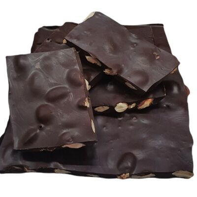 broken plate of dark chocolate with bulk almonds - organic