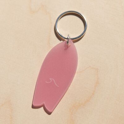 Translucent pink surfboard key ring with wave pattern
