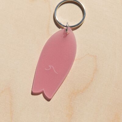 Translucent pink surfboard key ring with wave pattern