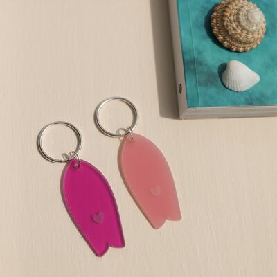 Translucent pink surfboard key ring with heart pattern