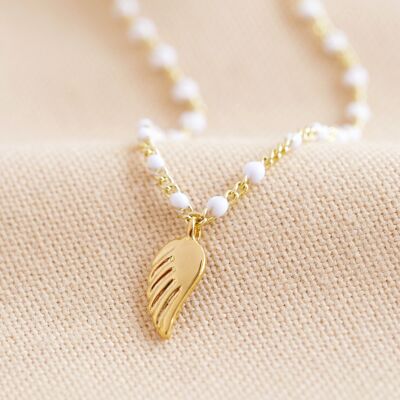 Collier de perles blanches en émail avec breloque aile en or