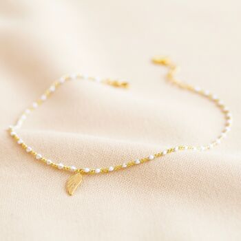 Bracelet de cheville à breloque aile perle blanche émaillée en or