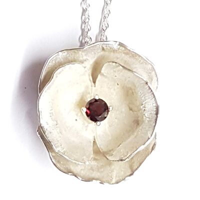 Poppy pendant hand made from Silver set with an African Garnet