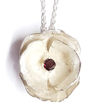 Poppy pendant hand made from Silver set with an African Garnet