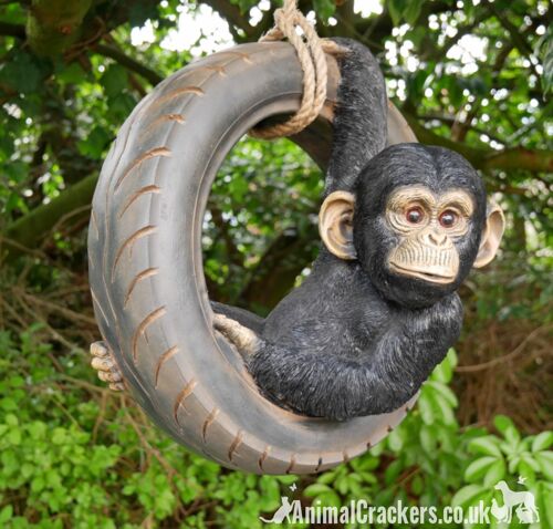 Chimpanzee swinging on old tyre rope swing, novelty tree garden ornament decoration, monkey or ape lover gift