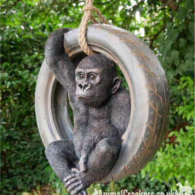 Gorilla swinging on old tyre rope swing, novelty tree garden ornament decoration, monkey or ape lover gift