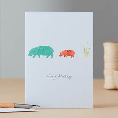 Tarjeta de cumpleaños de hipopótamo y hierba