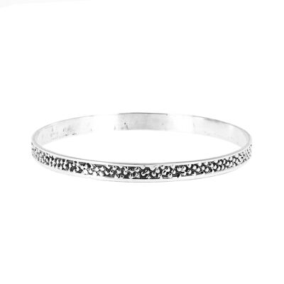 Silver bracelet decorated with small circles in relief
