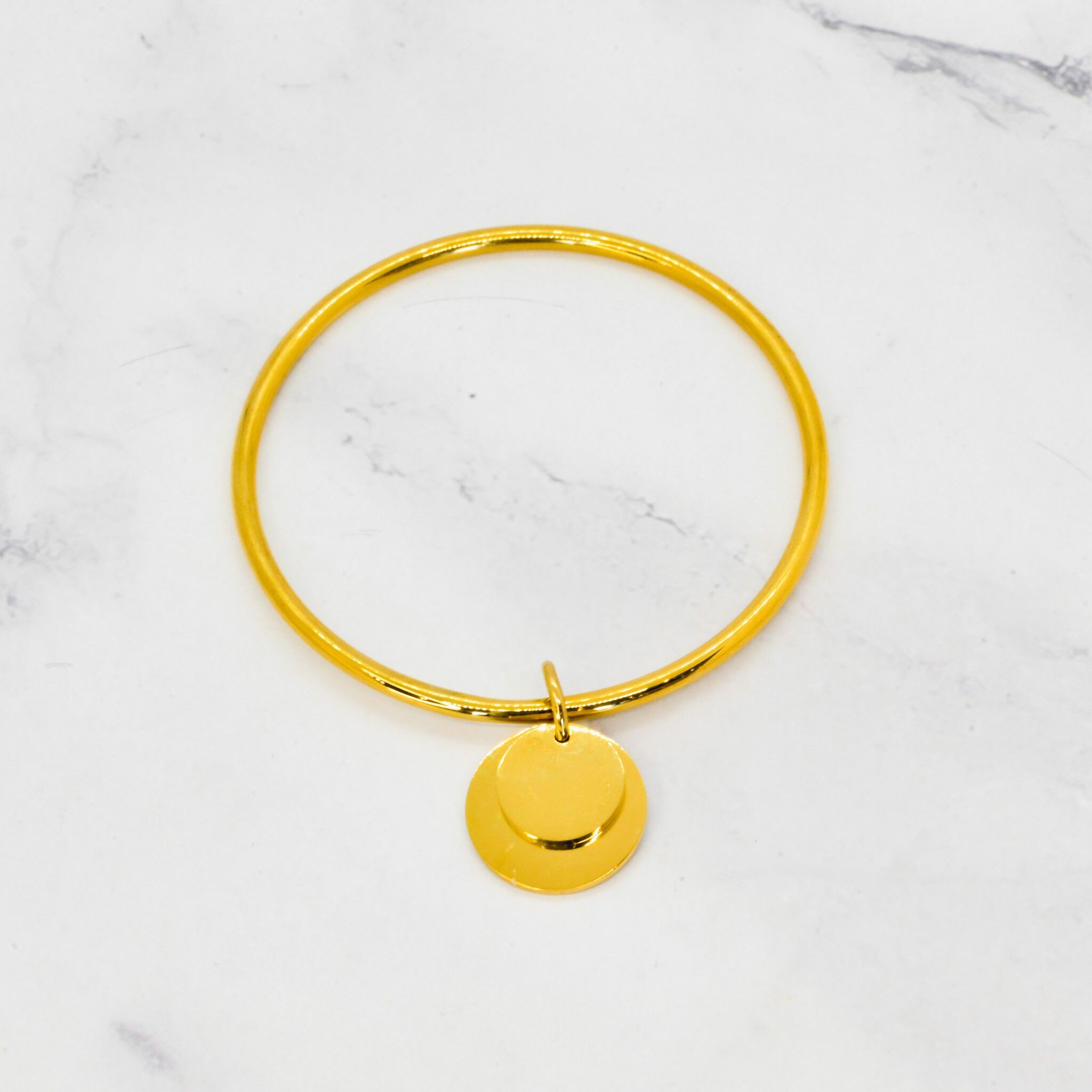 Bracciale rigido con doppia nappa in acciaio dorato