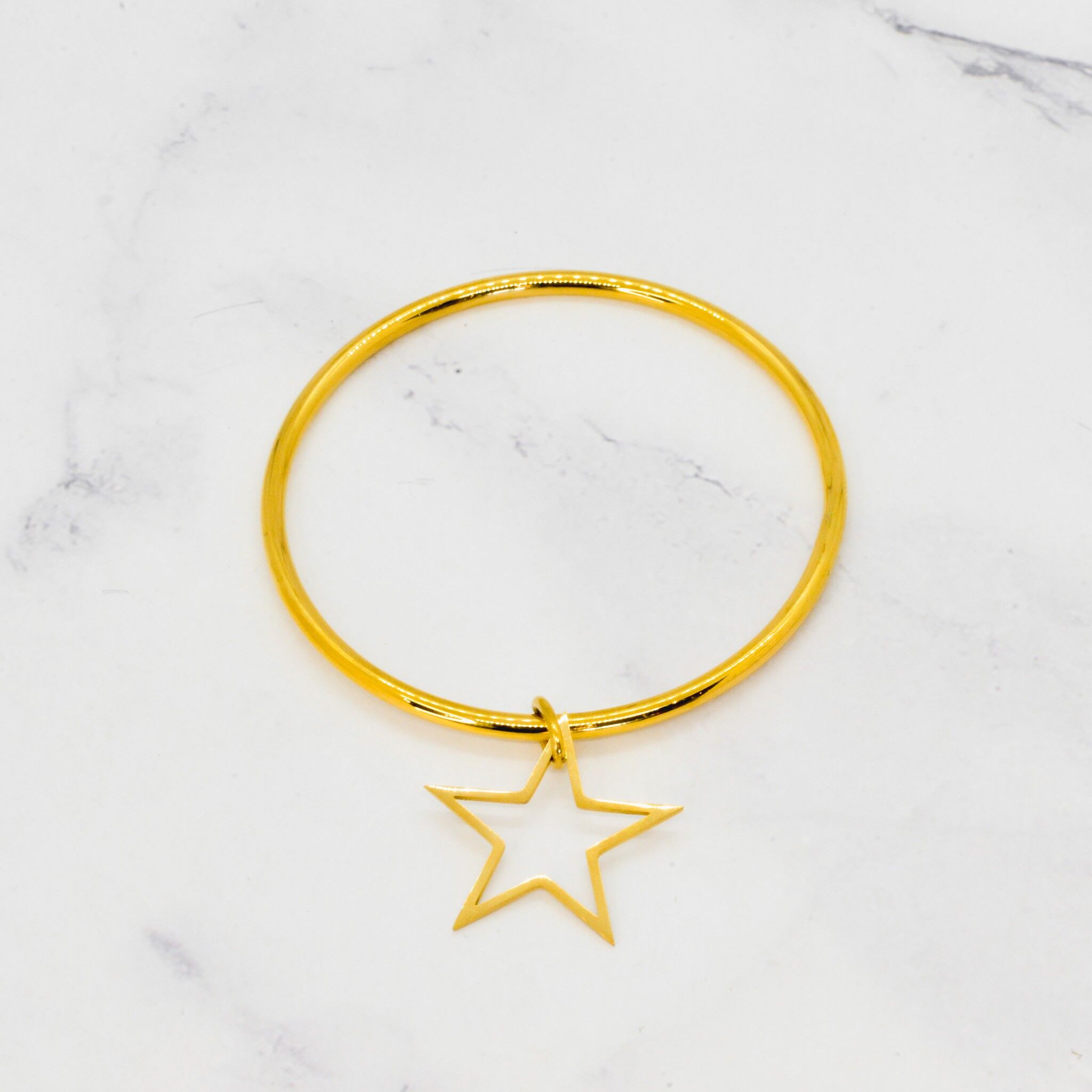 Bracciale rigido con nappa a stella in acciaio dorato