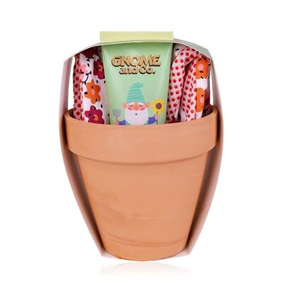 Coffret soin des mains GNOME & CO. dans un pot de fleurs, avec de la crème pour les mains et les ongles et des gants de jardinage