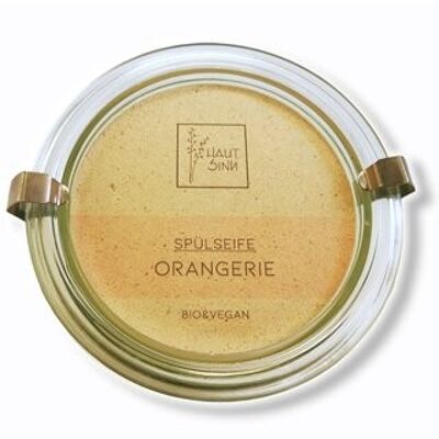 Orangerie organic dishwashing soap in a glass