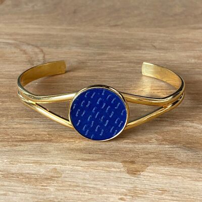 Bangle bracelet, indigo fabric and gold metal.