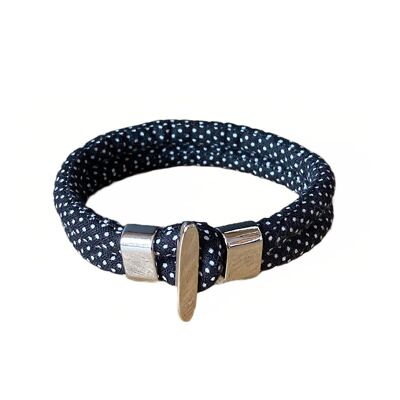 Bracciale in tessuto nero con pois bianchi.