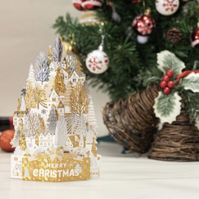 Cartolina di Natale 3D case bianche d'oro su una collina di neve