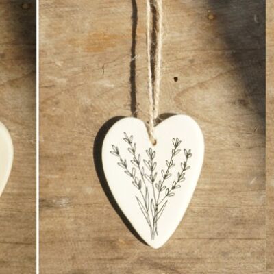 3 corazones colgantes con diseño botánico de semillas