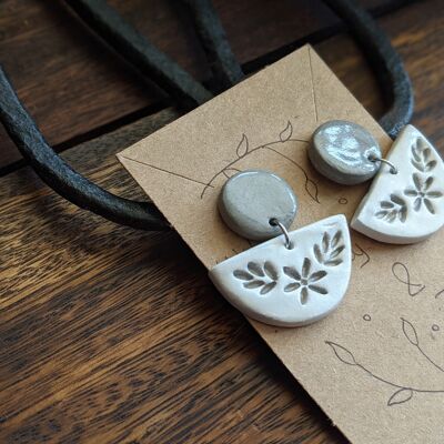 white embossed earrings with a grey stud