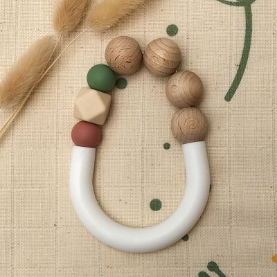 Green and terra-cotta teething ring in silicone and beech wood