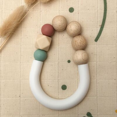 Terra-cotta and water green teething ring in silicone and beech wood