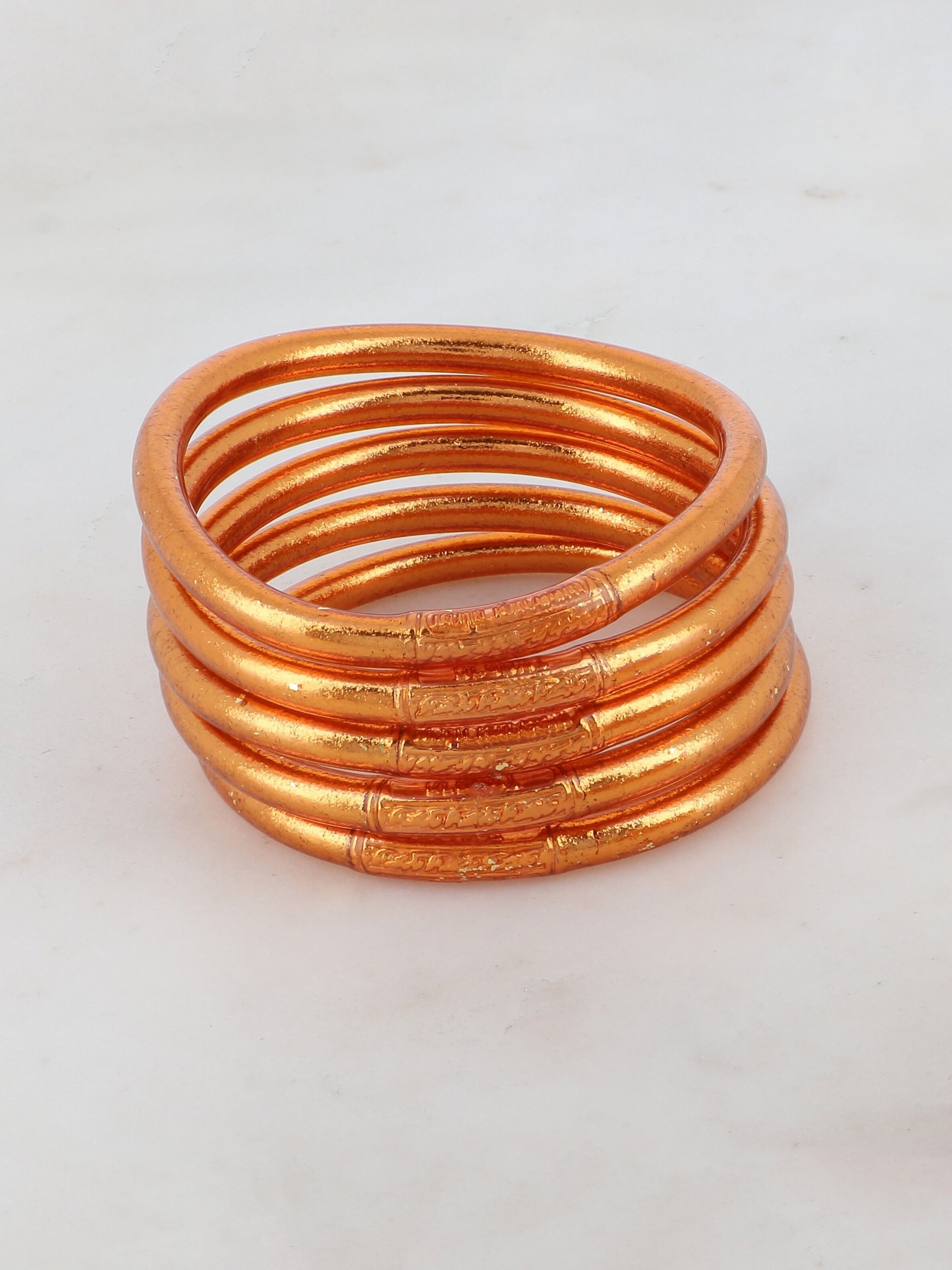 Gold bangles with copper store rod inside