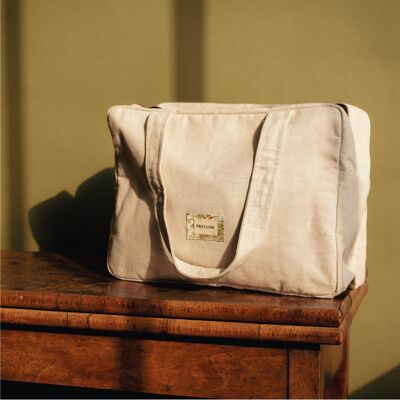 El bolso cambiador perfecto + colchón integrado - Delicado beige forrado con motivos selváticos
