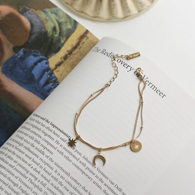 Bracciale con charm a doppia catena in oro