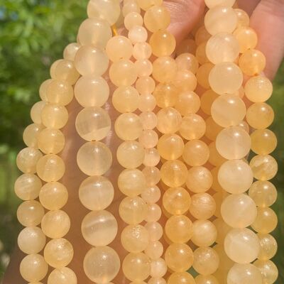 Perles en calcite jaune entre 6 et 10mm - 6mm
