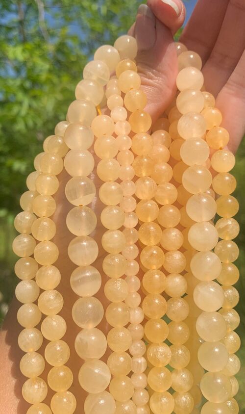 Perles en calcite jaune entre 6 et 10mm - 8mm