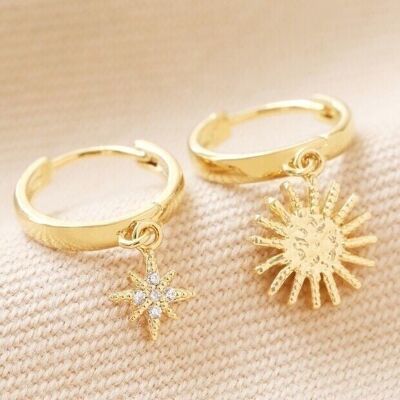 Aretes tipo argolla con dije de estrella y sol en dorado