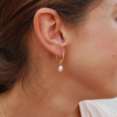 Silver hoop earrings with pearls.
