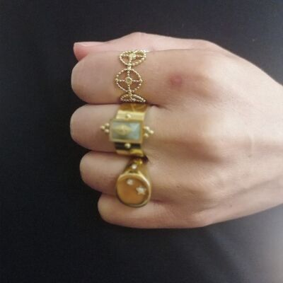 Adjustable ring with oval motifs, sun in the center