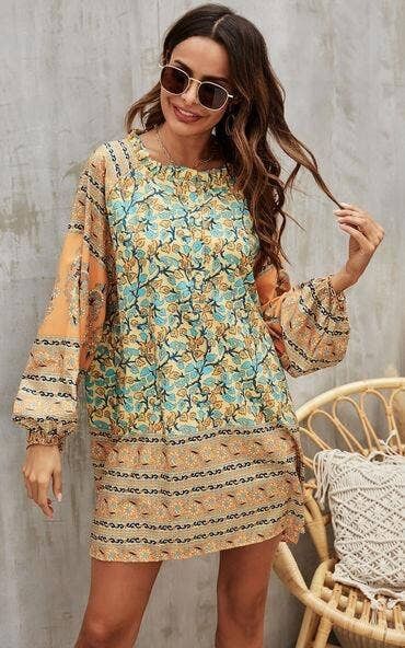 Abito grembiule a maniche lunghe con stampa floreale in arancione e verde