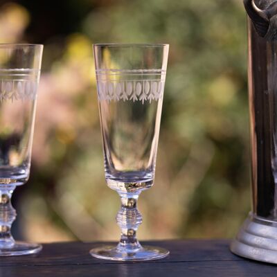 A Set of Four Crystal Champagne Flutes with Ovals Design