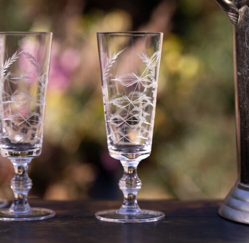 A Set of Four Crystal Champagne Flutes with Fern Design