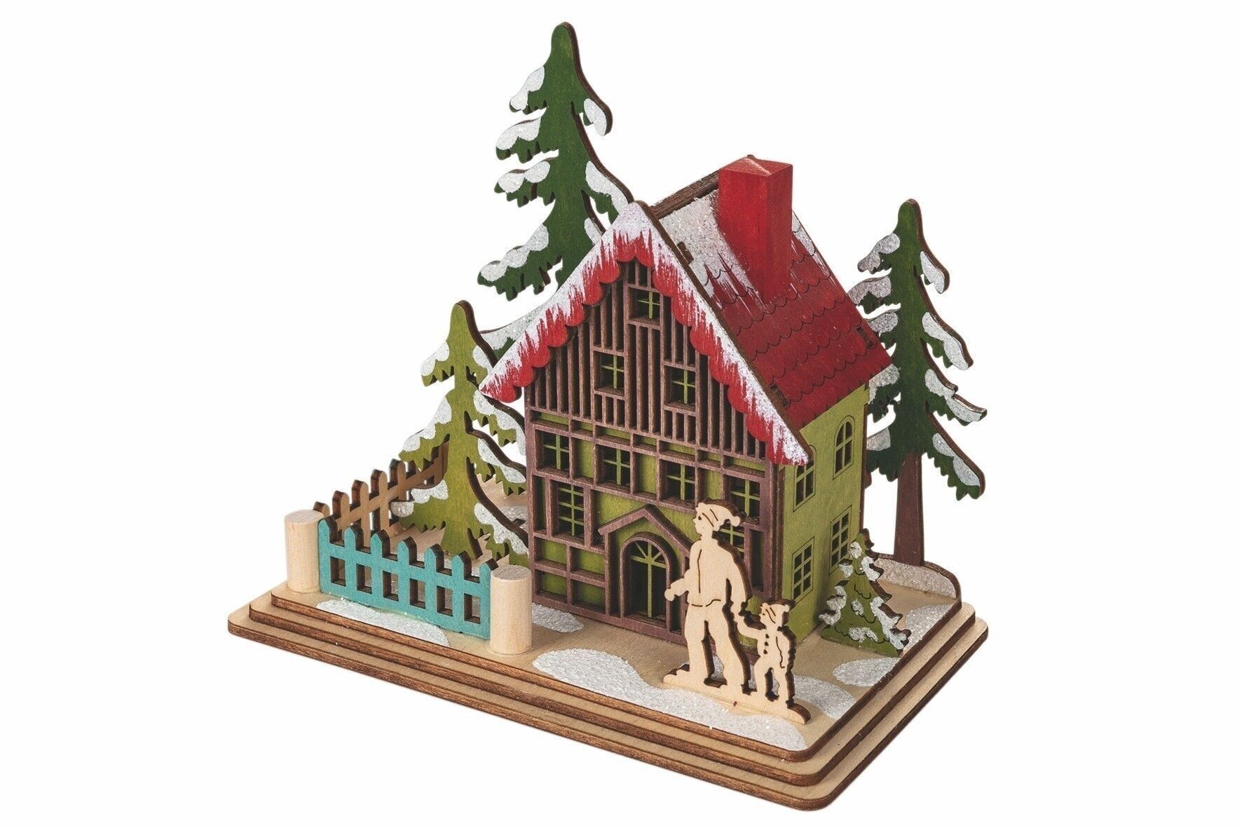 TRENDIGES SCHNEEBEDECKTES WEIHNACHTSHAUS MIT VATER UND SOHN