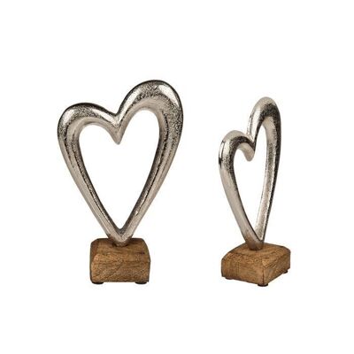 Silver-colored metal heart on a wooden base,