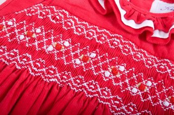 Robe en velours côtelé rouge smocké.  Dernière taille 12M 7