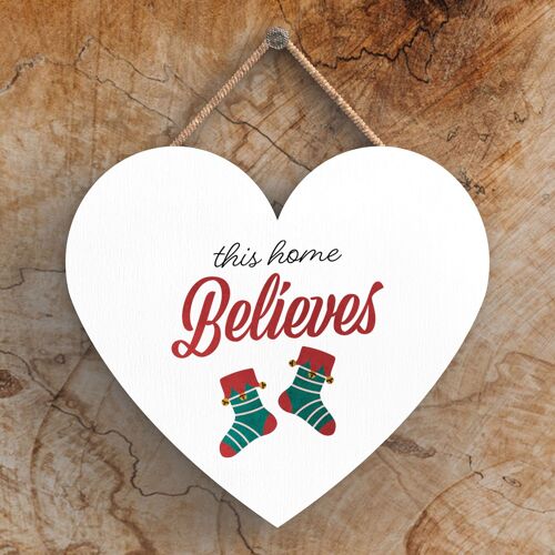 P2397 - This Home Believes Stockings Typography On A Heart Shaped Wooden Hanging Plaque
