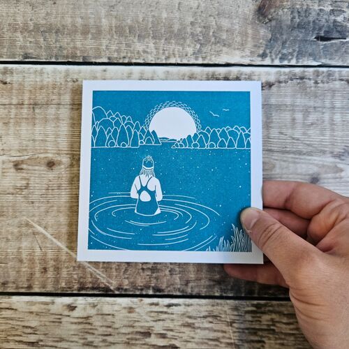 Sunrise Swimmer - Blank greeting card with a swimmer waist high in water under a rising sun