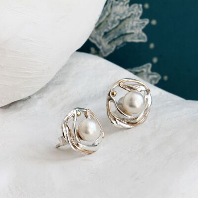 Pendientes ondulados de perlas de agua dulce plateadas con detalles dorados.