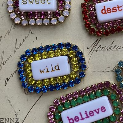 Brooch with rhinestones and words