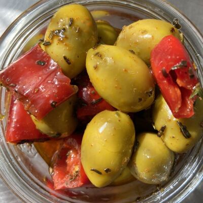 Broken green olives with chili peppers
