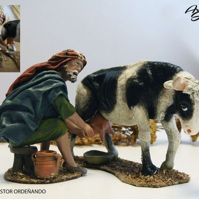 Shepherd milking cow, figures of the nativity scene