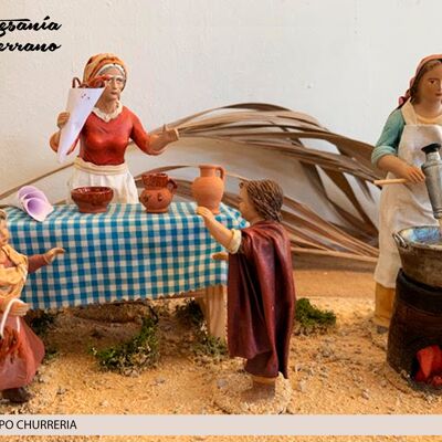 Gruppo di pastori che preparano i churros, figura del presepe